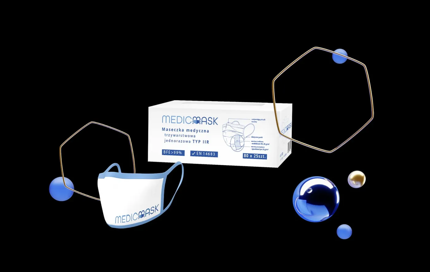 MedicMask - kompozycja produktowa: pudełko masek medycznych, wyjęta maseczka i dekoracyjne metalowe obręcze ze szklanymi kulami, na czarnym tle.