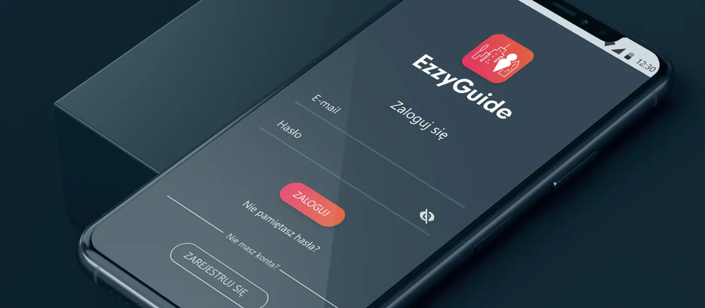 EzzyGuide - telefon ułożony po skosie na ciemnym tle z ekranem logowania: znak EzzyGuide, pola e-mail i hasło oraz przyciski „Zaloguj" i „Zarejestruj się".